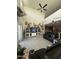 Living room with vaulted ceilings, ceiling fan, and entertainment center at 3012 N 310Th Ln, Buckeye, AZ 85396