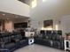 Inviting living room with high ceilings, black leather sofa, and modern decor at 3012 N 310Th Ln, Buckeye, AZ 85396