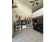 Spacious living area with vaulted ceilings, ceiling fan, and entertainment center at 3012 N 310Th Ln, Buckeye, AZ 85396
