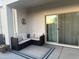 Covered patio with furniture, rug, pillows and a sliding glass door to the home's interior at 3012 N 310Th Ln, Buckeye, AZ 85396