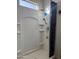 All-white shower stall features a modern shower head, handheld wand, and built-in shelving at 3012 N 310Th Ln, Buckeye, AZ 85396