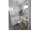 Cozy half bathroom features a pedestal sink, wood-look floors, and charming decor at 3085 E Patrick St, Gilbert, AZ 85295