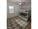Bright bedroom features a bunk bed, wood floors, and a neutral color scheme at 3085 E Patrick St, Gilbert, AZ 85295