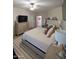 Spacious main bedroom boasts a king bed, dresser with TV, and neutral decor at 3085 E Patrick St, Gilbert, AZ 85295