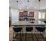 A gourmet kitchen island with granite countertops, pendant lighting and seating for casual dining at 3085 E Patrick St, Gilbert, AZ 85295
