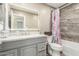 Well-lit bathroom with a gray vanity, marble countertop, stylish fixtures, and tile work at 3124 W Taro Ln, Phoenix, AZ 85027