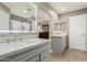 Elegant bathroom with dual sink vanity, lighted mirrors, and stylish tile flooring leading to bedroom at 3124 W Taro Ln, Phoenix, AZ 85027