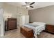 This bedroom offers a calming ambiance with neutral tones, a ceiling fan, and ample storage space at 3124 W Taro Ln, Phoenix, AZ 85027