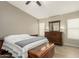 Comfortable bedroom featuring a ceiling fan, wood dresser, and ample natural light for a serene atmosphere at 3124 W Taro Ln, Phoenix, AZ 85027