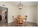 This dining area features a rustic wooden table and a modern light fixture, great for Gathering meals at 3124 W Taro Ln, Phoenix, AZ 85027