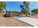 Exterior featuring a two-car garage, spacious driveway, and low-maintenance desert landscaping at 3124 W Taro Ln, Phoenix, AZ 85027