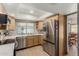Modern kitchen with stainless steel appliances, granite countertops, and ample natural light at 3124 W Taro Ln, Phoenix, AZ 85027