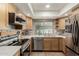This kitchen is beautifully appointed with stainless steel appliances, wood cabinets, and stylish backsplash at 3124 W Taro Ln, Phoenix, AZ 85027