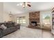 Cozy living room with brick fireplace, ceiling fan, and sliding doors to the backyard, perfect for relaxation at 3124 W Taro Ln, Phoenix, AZ 85027