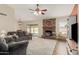 Inviting living room with a brick fireplace, ceiling fan and sliding glass doors to the backyard at 3124 W Taro Ln, Phoenix, AZ 85027