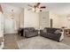 Cozy living room with neutral paint, tile flooring, comfortable seating, and a stylish ceiling fan at 3124 W Taro Ln, Phoenix, AZ 85027