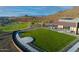 An aerial perspective showcasing lush green spaces and an accessible community building near walking trails and recreational areas at 32237 N 133Rd Dr, Peoria, AZ 85383