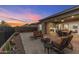 A beautiful backyard includes a fire pit, seating, and an unobstructed mountain view at 32237 N 133Rd Dr, Peoria, AZ 85383