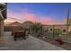 Backyard featuring desert landscaping, mountain views, and a wrought iron fence at 32237 N 133Rd Dr, Peoria, AZ 85383