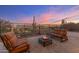 Backyard with desert landscaping, fire pit, seating area, and wrought iron fence at 32237 N 133Rd Dr, Peoria, AZ 85383