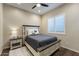 Comfortable bedroom with neutral tones, a queen-sized bed, and shuttered windows at 32237 N 133Rd Dr, Peoria, AZ 85383