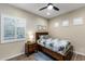 Bright bedroom featuring a window with white shutters and a queen-sized bed at 32237 N 133Rd Dr, Peoria, AZ 85383