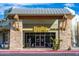 Exterior of a charming coffee shop with stone accents, large windows, and outdoor seating at 32237 N 133Rd Dr, Peoria, AZ 85383