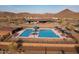 Overhead community pool shot with lounge chairs, shade covers, and community center at 32237 N 133Rd Dr, Peoria, AZ 85383