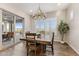 Cozy dining area with hardwood floors, shuttered windows, and a view of the outdoor patio at 32237 N 133Rd Dr, Peoria, AZ 85383