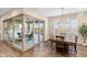 Bright dining room featuring wood floors, a modern chandelier, and a sliding door leading to outdoor patio at 32237 N 133Rd Dr, Peoria, AZ 85383