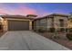Charming single-story home with a stone accent facade, desert landscaping, and a spacious two-car garage at 32237 N 133Rd Dr, Peoria, AZ 85383