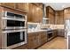 Well-equipped kitchen with stainless steel appliances and fixtures and custom cabinets for modern convenience at 32237 N 133Rd Dr, Peoria, AZ 85383