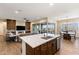 Open-concept kitchen with a spacious island, modern appliances, and seamless access to the outdoor patio at 32237 N 133Rd Dr, Peoria, AZ 85383