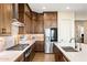 Modern kitchen featuring stainless steel appliances, gas range, and a large island with sink and ample counter space at 32237 N 133Rd Dr, Peoria, AZ 85383