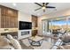Cozy living room featuring built-in cabinetry, a modern fireplace, and access to the outdoor patio at 32237 N 133Rd Dr, Peoria, AZ 85383