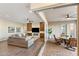 Open-concept living room with hardwood floors and seamless access to the outdoor patio and dining area at 32237 N 133Rd Dr, Peoria, AZ 85383