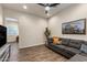 Cozy living room featuring modern gray sofa, wood flooring and natural light at 32237 N 133Rd Dr, Peoria, AZ 85383