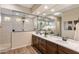 Modern main bathroom featuring double sinks, vanity, and a large glass-enclosed shower at 32237 N 133Rd Dr, Peoria, AZ 85383