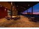 Outdoor lounge area featuring a fireplace and comfortable seating, ideal for gatherings and relaxation at 32237 N 133Rd Dr, Peoria, AZ 85383