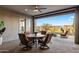 Covered patio features outdoor seating area with ceiling fan and views of the backyard at 32237 N 133Rd Dr, Peoria, AZ 85383