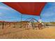Community playground with climbing structures, slide, and a shade canopy, enhancing outdoor recreational opportunities at 32237 N 133Rd Dr, Peoria, AZ 85383
