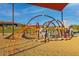 Community playground with climbing structures, slide, and shade in a well-maintained, safe recreational environment at 32237 N 133Rd Dr, Peoria, AZ 85383