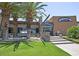 Exterior view of V's Taproom showcasing stone accents, palm trees, and a manicured lawn at 32237 N 133Rd Dr, Peoria, AZ 85383