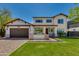 Inviting two-story home with a manicured lawn, brick accents, and a charming front porch at 3229 E Campbell Ave, Phoenix, AZ 85018