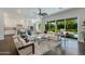 Open-concept living room with a plush sofa, hardwood floors, and sliding doors to the backyard at 3229 E Campbell Ave, Phoenix, AZ 85018