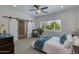 Serene main bedroom with a sliding barn door, a decorative wood wall, and sunlit window at 3229 E Campbell Ave, Phoenix, AZ 85018