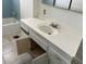 Bathroom featuring a sink with an open cabinet below, bathtub, and basic tile flooring at 3419 W Glenn Dr, Phoenix, AZ 85051