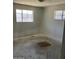 Bedroom with two windows and unfinished flooring at 3419 W Glenn Dr, Phoenix, AZ 85051