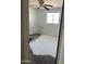 Bedroom featuring a ceiling fan, window, and unfinished flooring at 3419 W Glenn Dr, Phoenix, AZ 85051