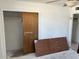 Bedroom features closet with sliding door and unfinished flooring at 3419 W Glenn Dr, Phoenix, AZ 85051